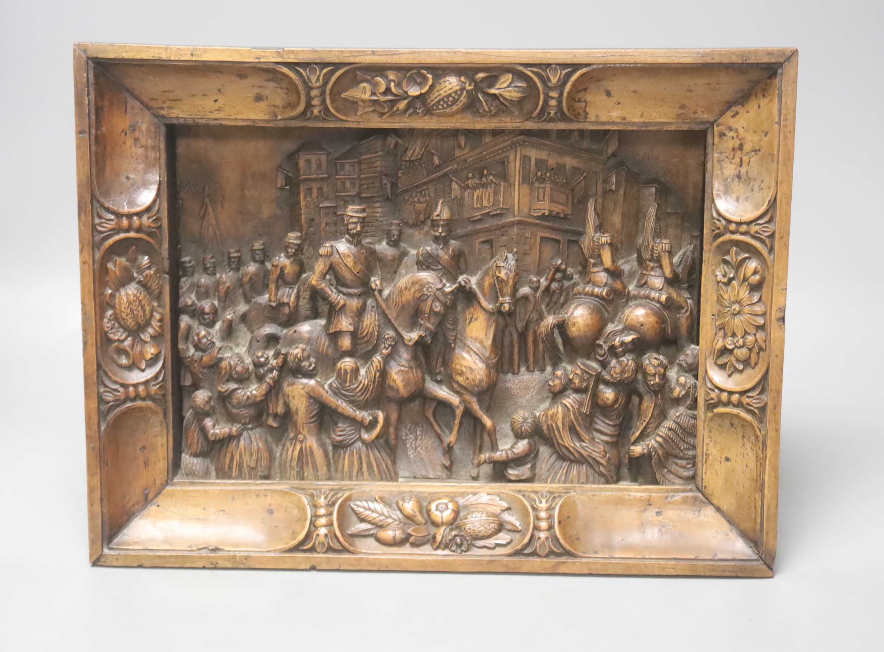 A 19th century Continental relief carved fruitwood plaque depicting a procession, 39 x 30cm